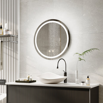 Round LED bathroom mirror with illuminated edge light above white sink