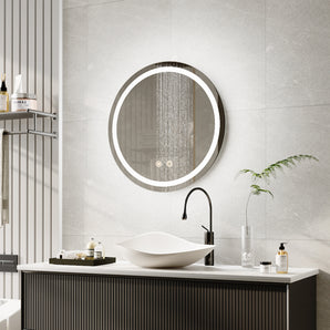 Round LED bathroom mirror with illuminated edge light above white sink