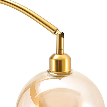 Close-up of gold lamp stem and glass globe shade