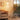 Modern arc floor lamp with glass globe bulb and wood tray, black pole, gold accents
