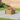 Plastic wood-grain raised garden bed planter with corner posts and rounded top