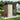 Brown metal garden storage shed with cream door panels and diagonal brace, pent roof.