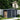 Metal garden storage shed with log store, dark gray sliding doors, apex roof