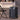 Black 2-drawer makeup travel case with central lock, side handle, and caster wheels