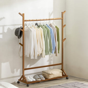 Bamboo garment rack with hanging bar, side pegs, hat holder, and wheels