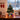 Mini artificial Christmas tree with gold star, pink and gold baubles, lights, gift boxes