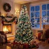 Artificial Christmas tree with lit branches and red ornaments, on metal stand.