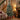 Artificial Christmas tree with lit branches, red baubles, on metal stand.