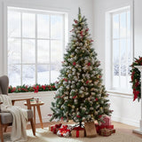 Artificial Christmas tree with lit branches and red ornaments on metal stand.