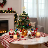 Tabletop Christmas tree decoration with gold star topper, red and blue baubles, LED string lights