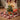 Decorative tabletop Christmas tree with gold star topper, multicolor baubles, glowing LED lights