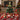 Tabletop Christmas tree decoration with gold star topper, assorted ornaments, LED lights, wrapped in pot