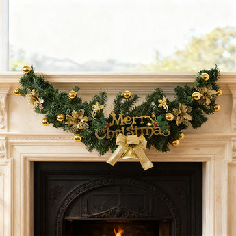 Christmas garland swag with green foliage, gold baubles, pinecones, and Merry Christmas sign