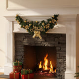 Christmas garland swag with green foliage, gold ornaments, and Merry Christmas centerpiece