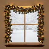 Artificial Christmas wreath with green pine branches, warm LED lights, and red bauble details