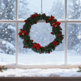 Artificial Christmas garland wreath with green pine, red poinsettias, and red baubles