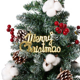Artificial Christmas tree decoration with “Hey Christmas” sign, red ornaments, and pinecones