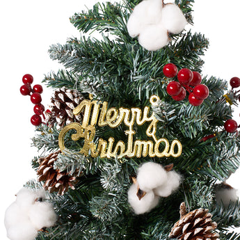 Artificial Christmas tree decoration with “Hey Christmas” sign, red ornaments, and pinecones
