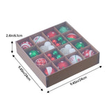 Christmas tree ornaments in divided gift box with assorted red, green, and white baubles.