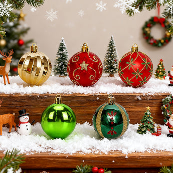 Christmas ornaments on snowy wooden display: gold, red, green baubles and teardrops