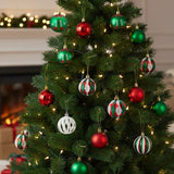 Christmas tree ornaments: red, green, and striped baubles hanging on branches