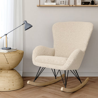Beige faux wool upholstered rocking chair, side view with armrests and black metal base