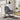 Grey nursery rocking chair with padded backrest, thick seat, and black metal rockers