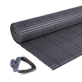 Dark gray PVC privacy screen sheet rolled out with square grid reinforcement