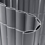 Rolled PVC privacy screen showing tightly wound vertical slats and ties