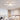 Five-petal modern LED semi-ceiling luminaire with white ring lights, softly glowing