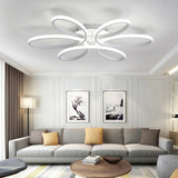 Modern LED semi-ceiling light with five white oval petal rings and a central hub