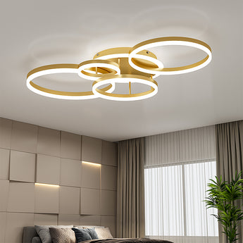 Gold 5-ring LED ceiling light with five staggered circular loops on a flush mount