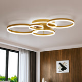Gold 5-ring LED ceiling light with five circular loop frames and white inner glow