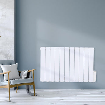 Wall-mounted white electric radiator heater with vertical fins on a light blue wall