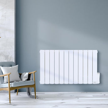 Wall-mounted white electric radiator heater with vertical fins, shown in a living room