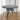 Black round tabletop with parasol hole and curved metal legs for outdoor dining