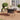 Outdoor woven table with round dark top and a central parasol hole.