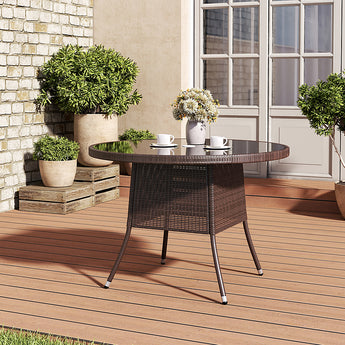 Outdoor woven table with round dark top and a central parasol hole.