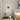 Black linear LED wall sconce with round backplate and vertical bar, white light