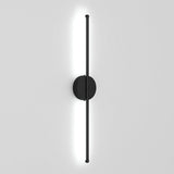 Black linear LED wall sconce with round backplate and vertical light bar, bright white