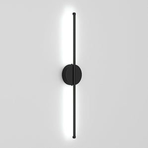 Black linear LED wall sconce with round backplate and vertical light bar, bright white