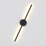 Black linear LED wall sconce with round mounting plate and diagonal vertical bar, warm glow