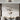 Black ring-shaped LED pendant light with circular glowing bands and hanging cords
