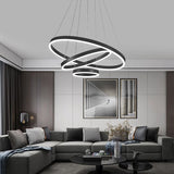 Black multi-ring LED pendant light with bright circular light rings on cords