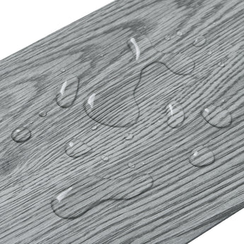 Close-up of grey PVC wood plank flooring grain and raised texture