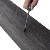 Dark grey woodgrain PVC plank edge, adhesive backing and cutting line