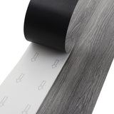 Self-adhesive PVC laminate plank with dark grey woodgrain pattern
