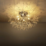 Gold Sputnik flush mount ceiling light, glowing central bulb and dangling strands
