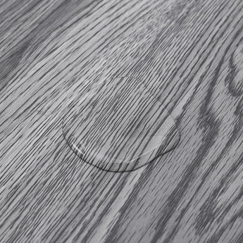 Grey wood-effect grain close-up on smooth PVC flooring