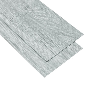 Gray wood-effect PVC flooring tile with edge alignment seam and layered plank look